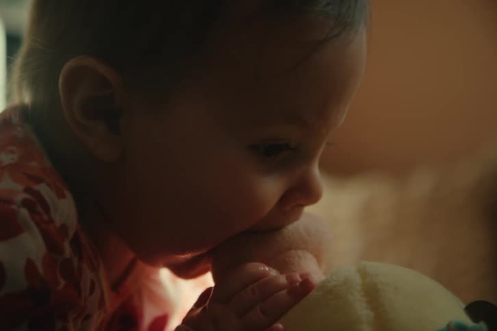 Baby biting a stuffed animal