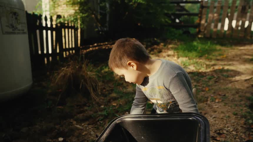 Boy playing with a wheelbarrow