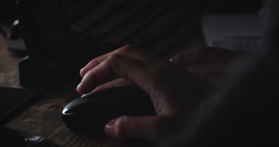 Hand interacting with computer mouse