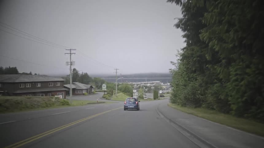 Urban street with vehicle traffic on a cloudy day