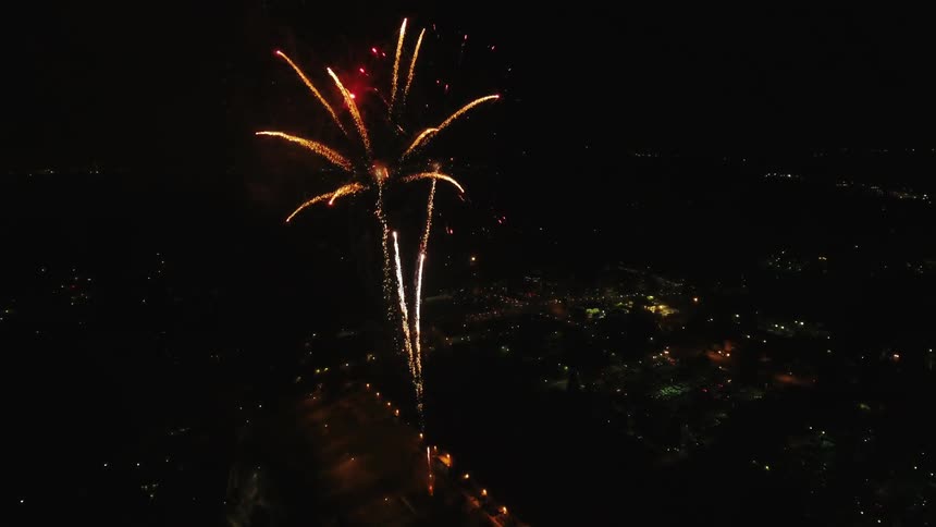 Fireworks shooting up over a city