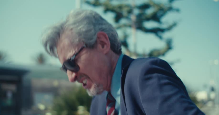 Man hears good news on a phone call and reacts with joyful triumph