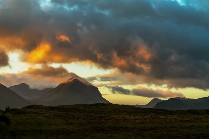 Dramatic sunrise clouds and color over distant peaks. Timelapse