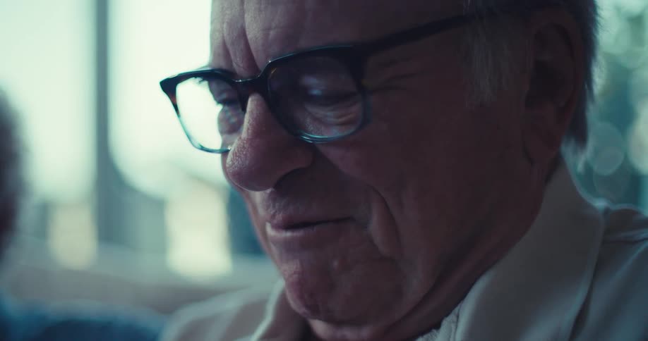 A man smiles as he is talking with a woman