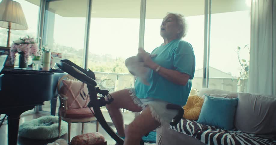 A woman is sweating while using an exercise bike