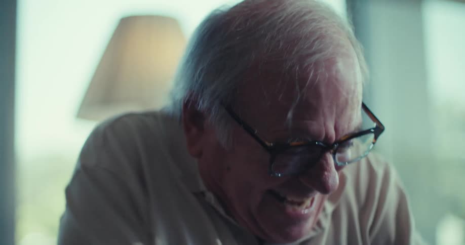 Two elderly people with happy expressions talking to each other