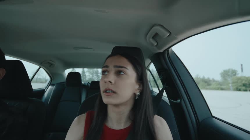 A teenager is nervous as she drives
