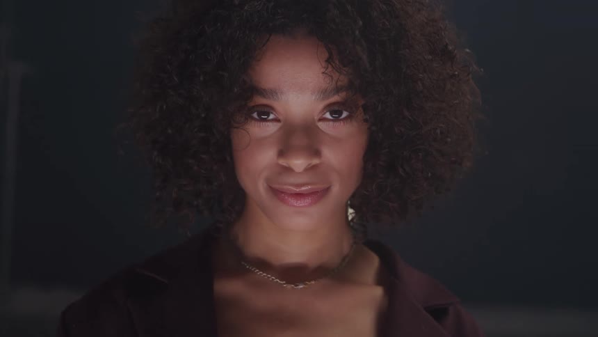 Curly haired woman with happy expression