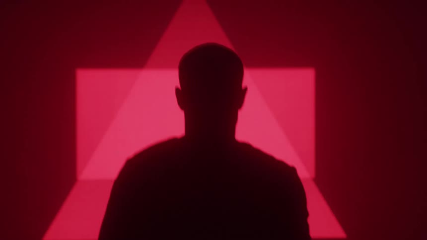 Man is walking fast towards the flashing red symbols