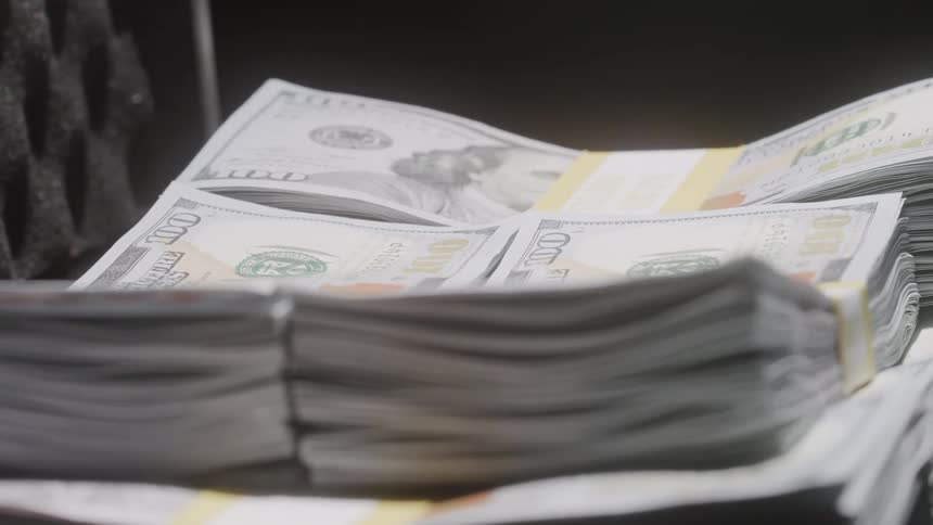 A briefcase of cash is spinning