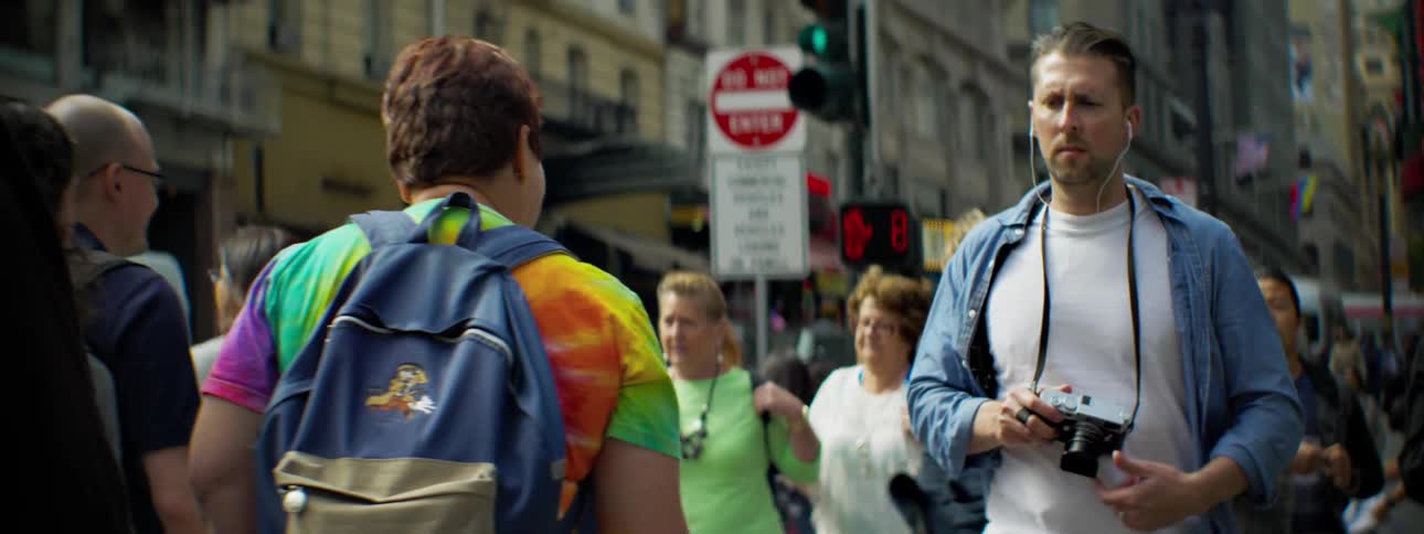 People walk on a windy sidewalk