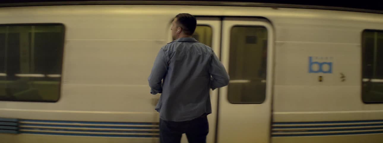 A man waits for a train at a subway stop