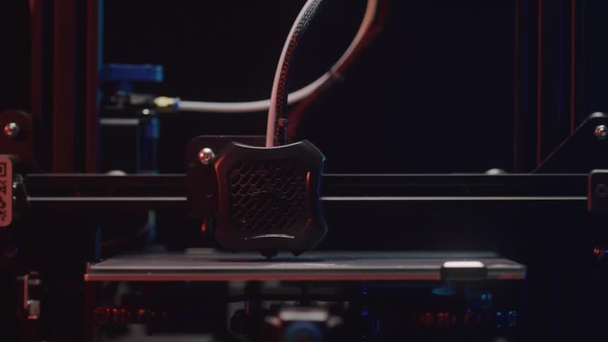 A 3d printer moves left and right as it creates an object layer by layer