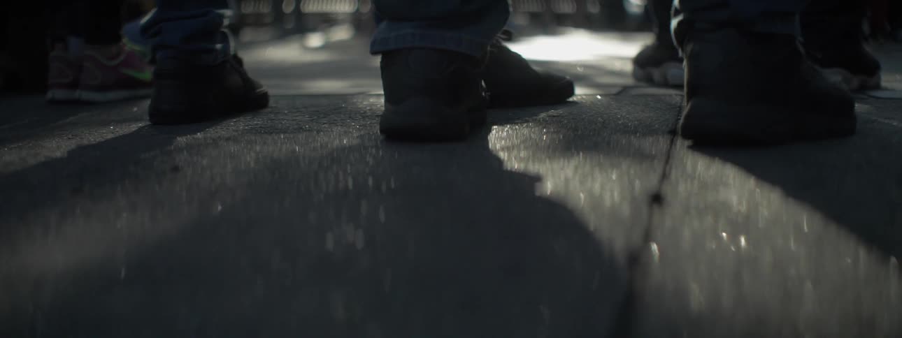 People stand on sparkling concrete