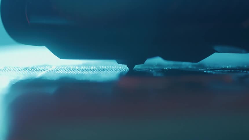 A 3d printer stylus moves back and forth across a surface as it prints