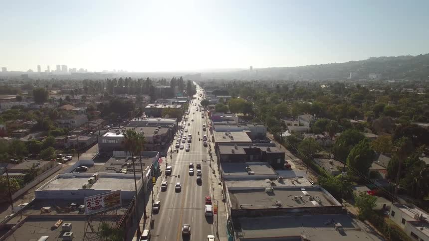 A vast hazy urban landscape stretching towards a distant skyline over Melrose Avenue in Los Angeles