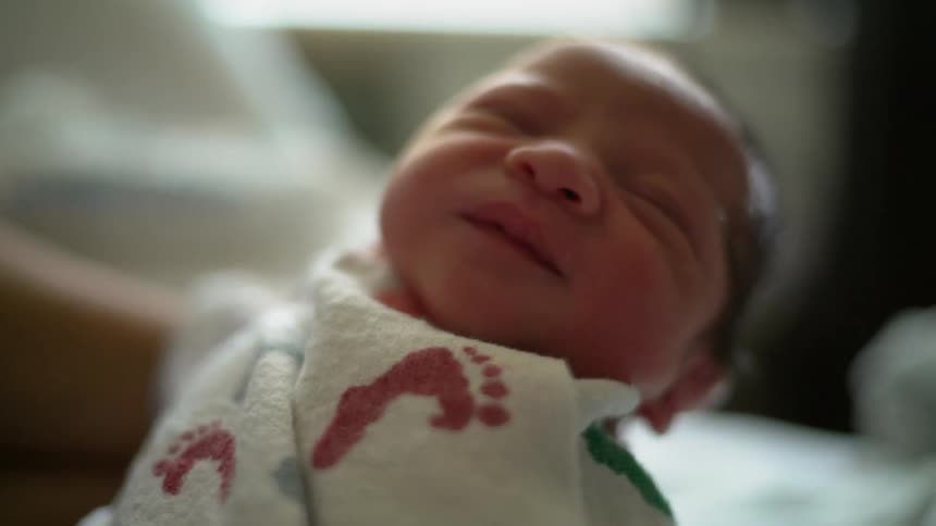 A small infant opens and shuts its mouth