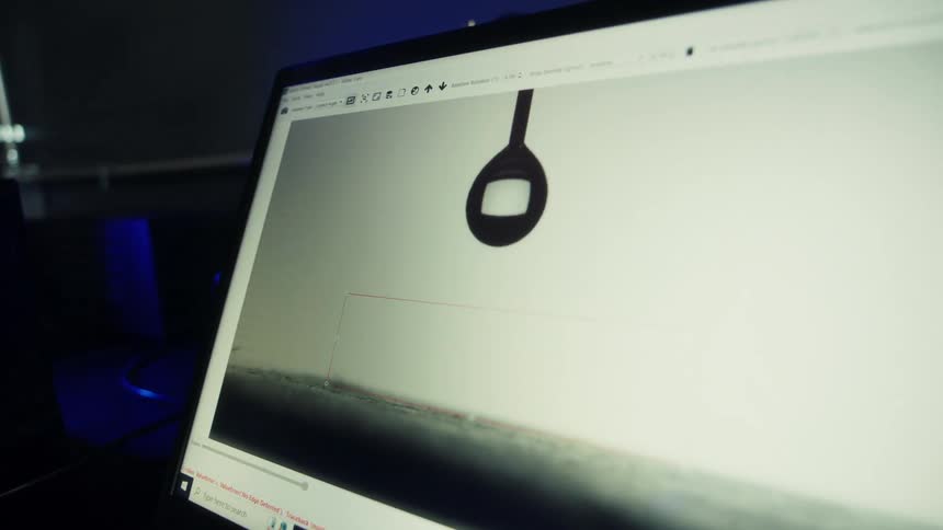 A person is doing graphic design on a computer at night time