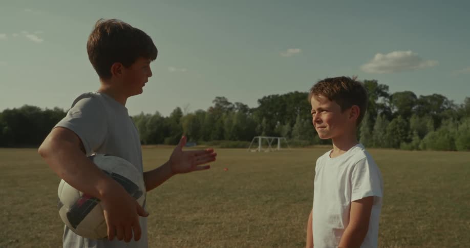 Two children having a conversation outdoors during spring