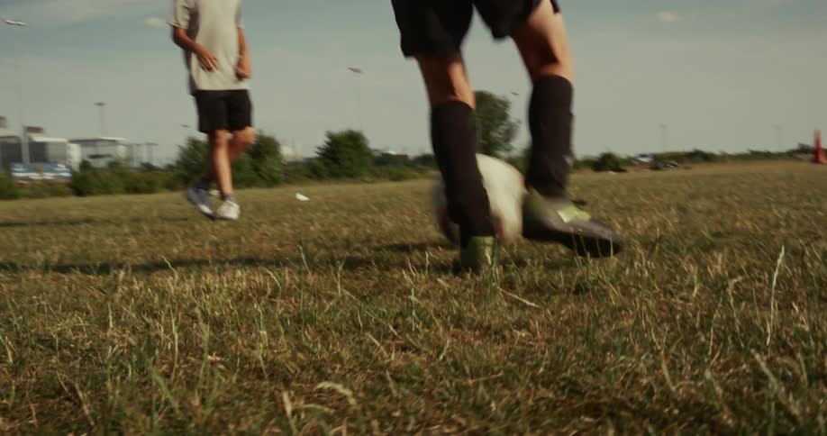 Two boys are practicing to play a game of soccer