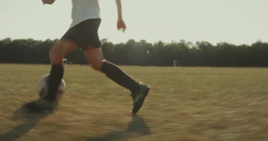 Two kids are running and playing a game of soccer