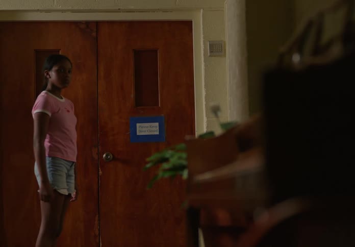 A girl walks through the room
