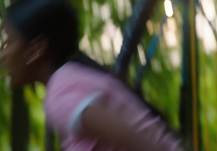 Boy in a park taking a cell phone from another girls hand