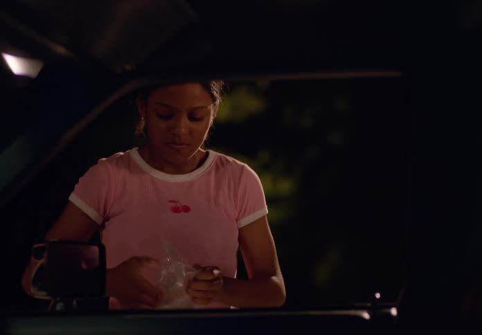 Woman breaking a car window and taking a bag with objects