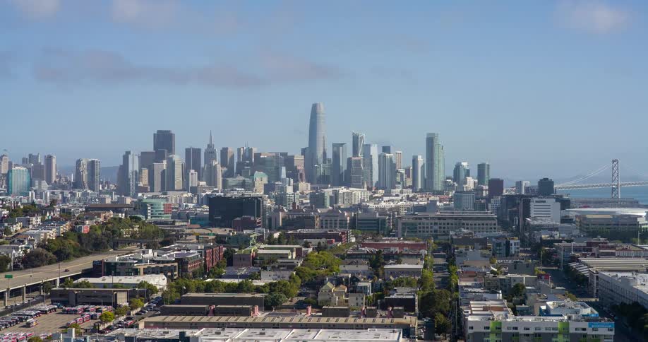 A wide view of downtown san francisco framed by residential neighborhoods and elevated highways