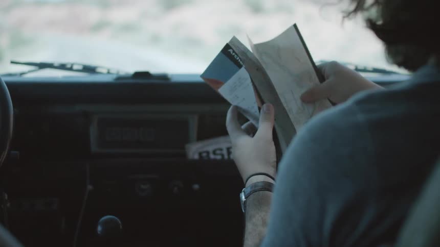A person folding a map