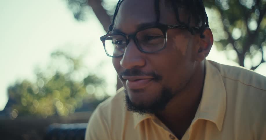 Man sitting on a bench with a happy expression