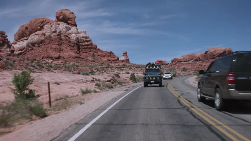 Vehicles driving on a desert road