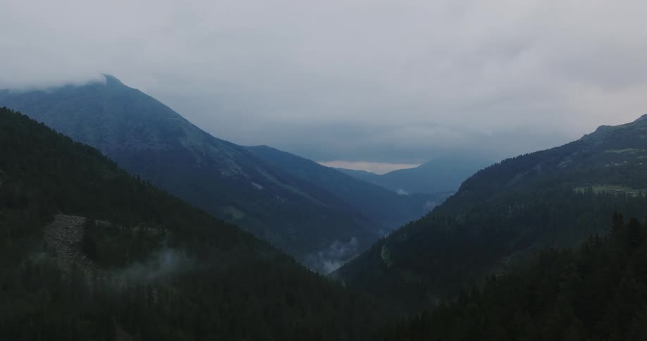 Aerial panorama of mountains with forests on a cloudy day