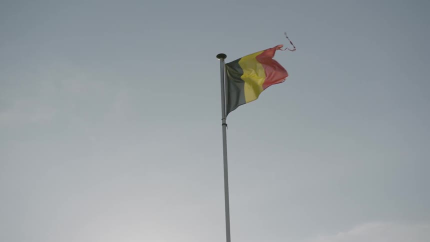 A belgian flag waves in the breeze