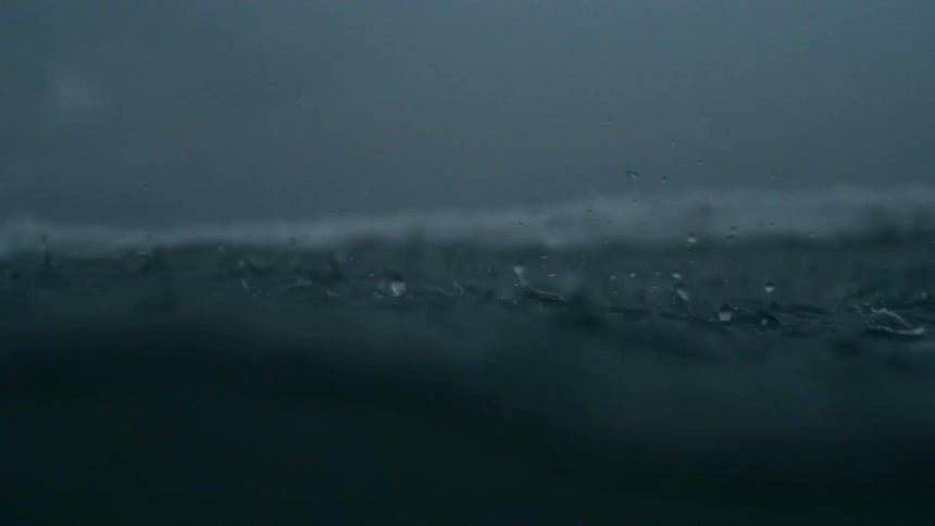 Close up of rain drops falling into the sea during a storm