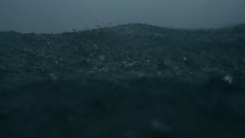 Heavy rain falling into a rough ocean