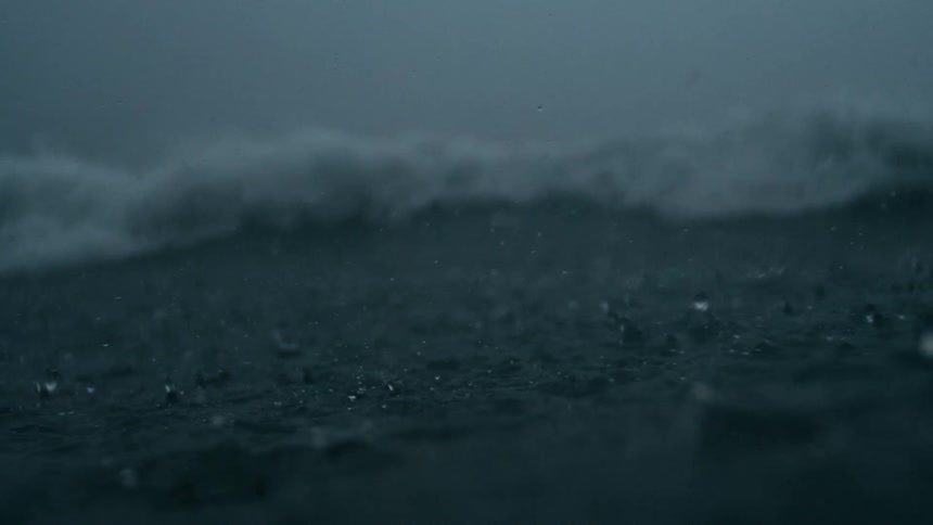 Heavy rain falling into a rough sea