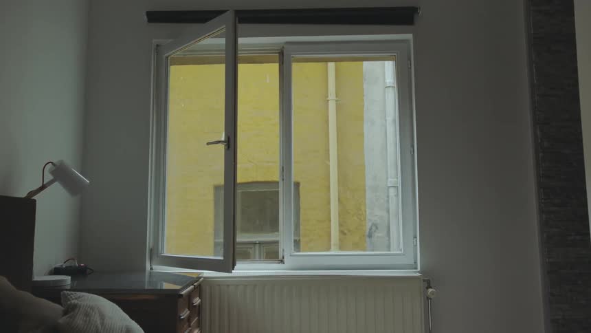 A bedroom window sits partially opened