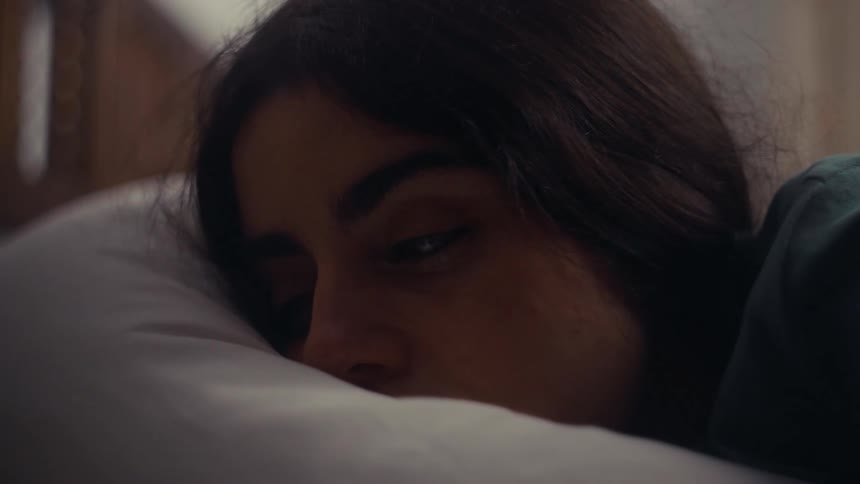 A girl wakes up from bed