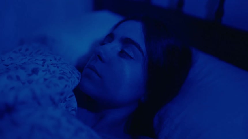 A girl wakes up at night in bed