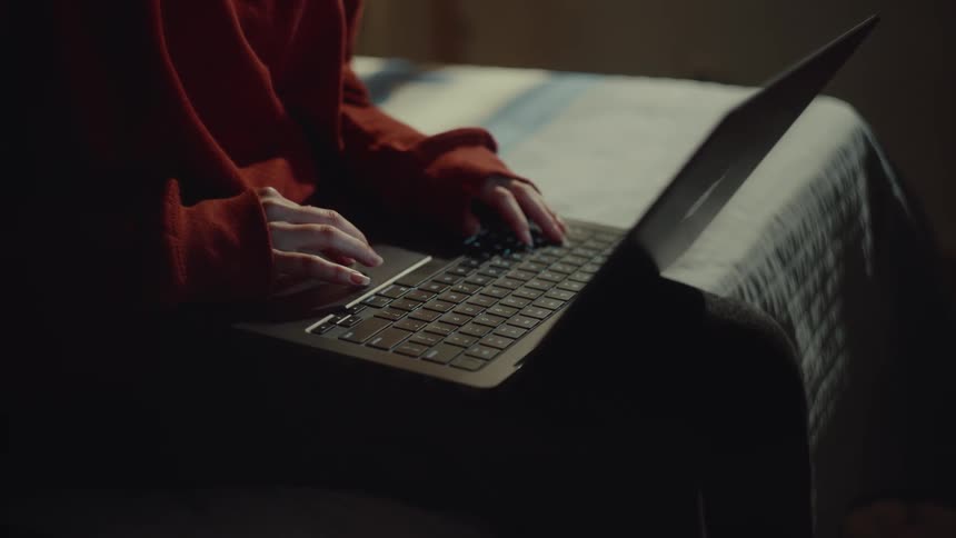 A teenager uses her laptop then closes it