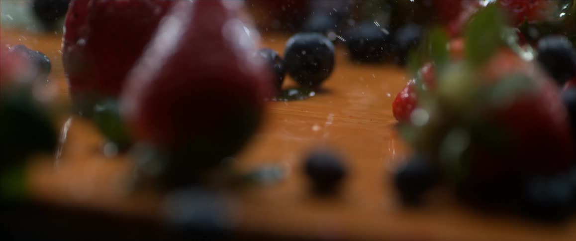 A scenery of berry fall to the table