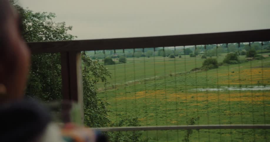 Person sitting on porch smoking and drinking