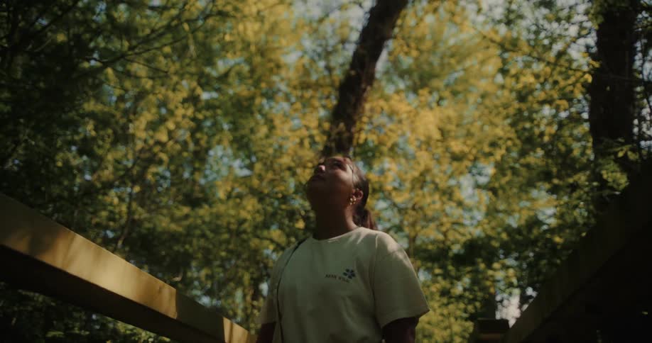 Woman in a forest looking up