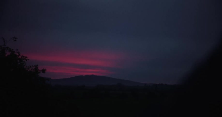 Silhouette of mountains on the horizon in a purple sky landscape at dawn