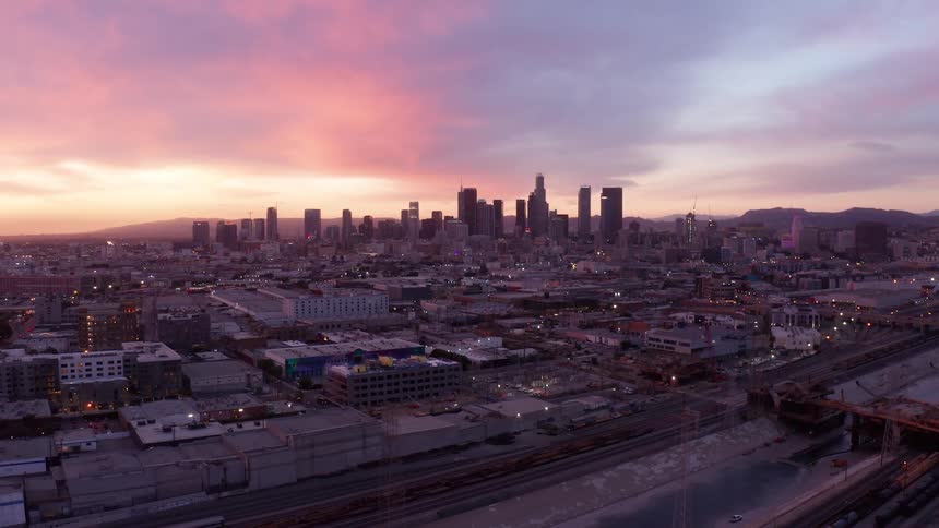 Panorama of a metropolis with the reddish and cloudy sky of dawn