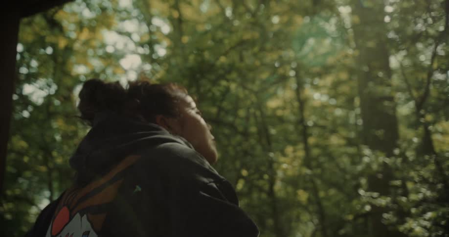 Woman in a forest using binoculars