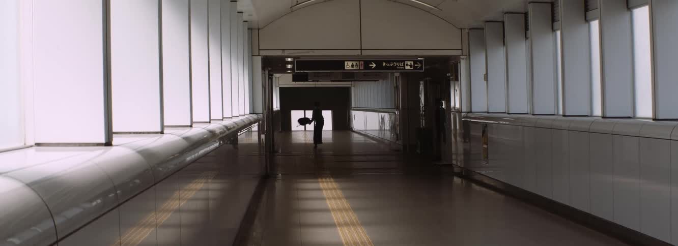 A moody moment in the metro as a child swings his backpack around feeling free