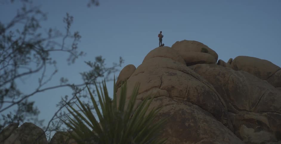 A person is standing at the top of the mountain