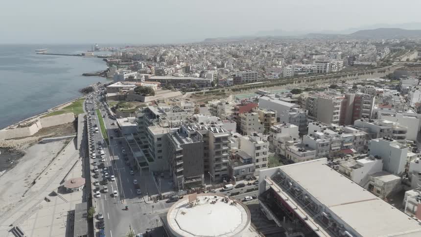 A traffic jam is by the shore of the city